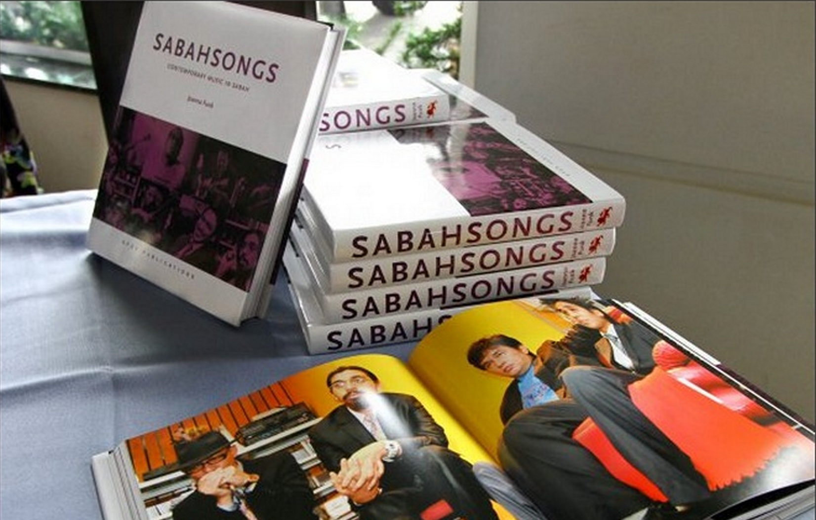 a pile of the SabahSongs: Contemporary Music in Sabah book, written by Joanna Funk, on a table