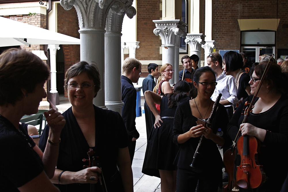 Musicians waiting outside before the performance starts
