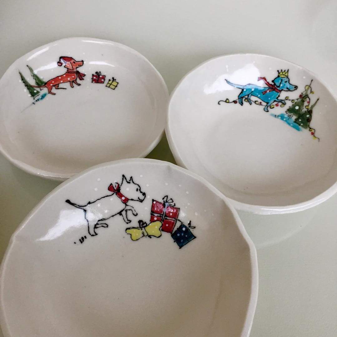 Hand-made porcelain dishes with hand-drawn little dogs in the snow by Mary Funk-Butterworth. For sale at the Putney School of Art and Design Christmas Fair