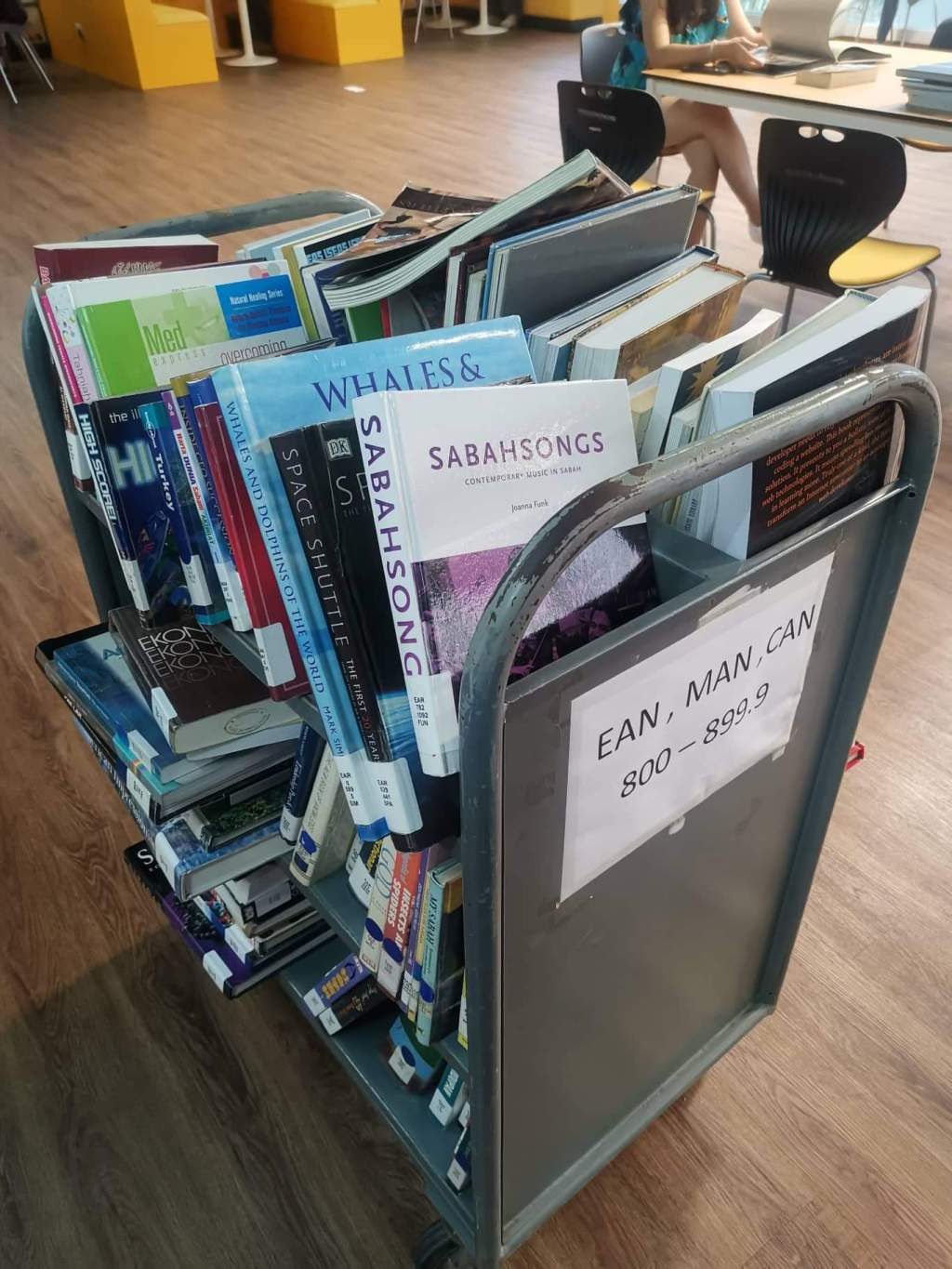 SabahSongs book on a trolley of books in new library in Tanjung Aru, an area in Kota Kinabalu, Sabah, Malaysia