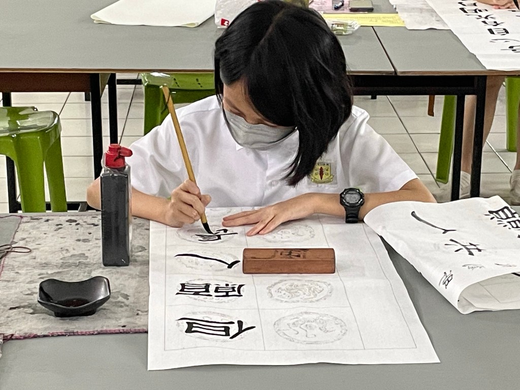 Young girl writing Chinese calligraphy